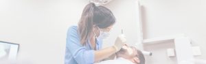 Dental professional examining a patients teeth