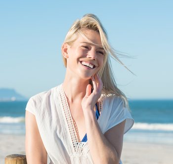 young woman smiling on the beach